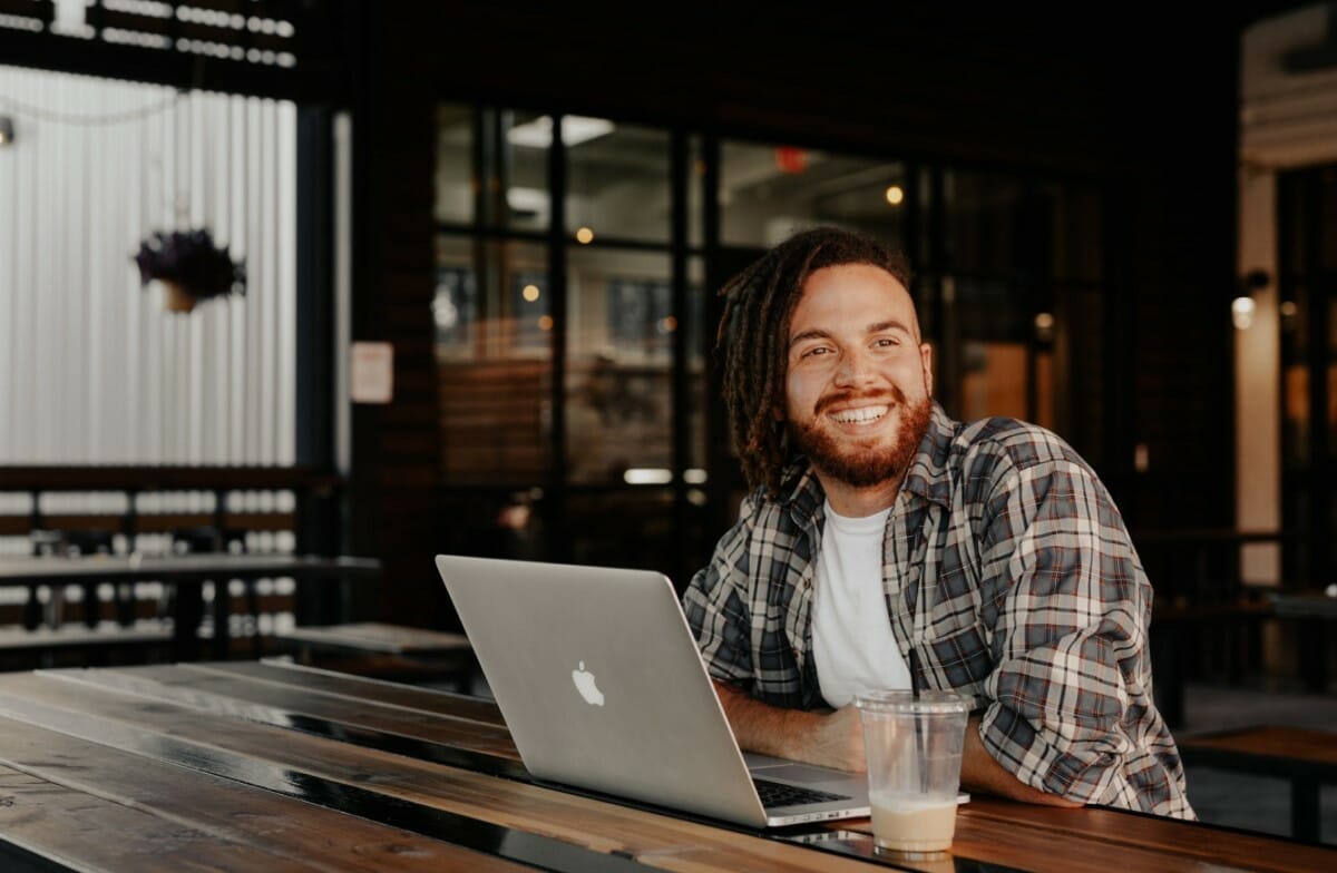 man with laptop in a cafe